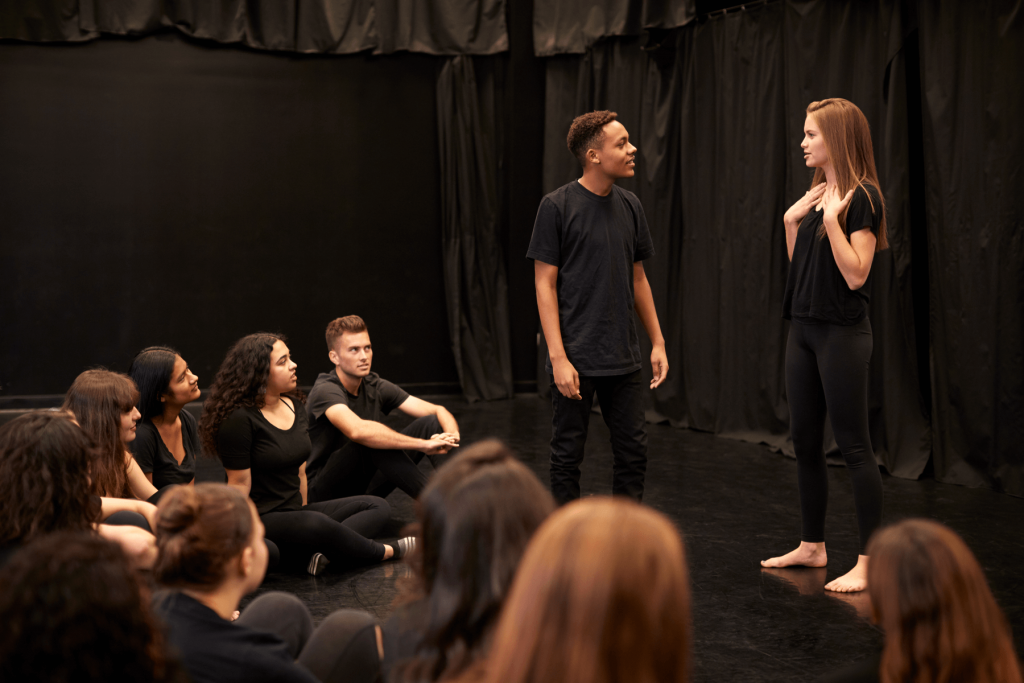 Young Woman Teaching Acting Class Dressed in Black