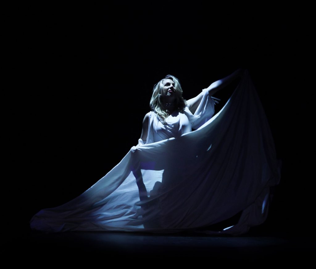 Woman in White Dress Isolated on Stage