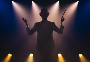 Silhouette of magician with a wand